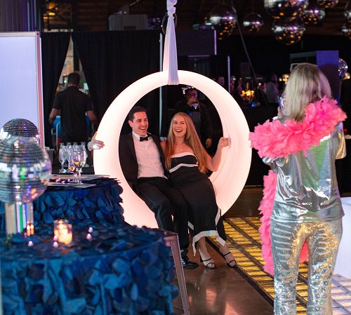 Couple getting their photo taken in a round lighted swing